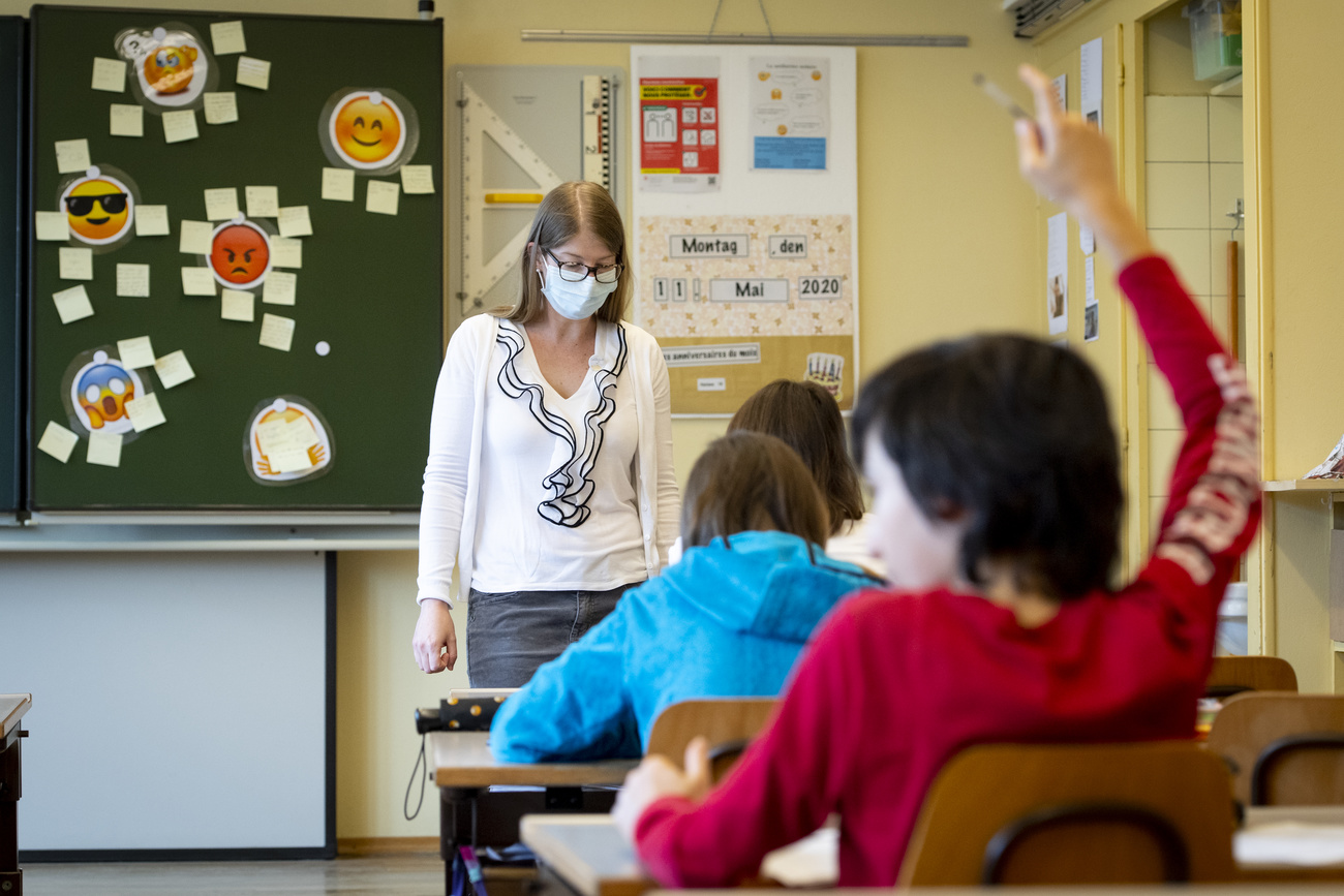 schoolroom with teacher in mask