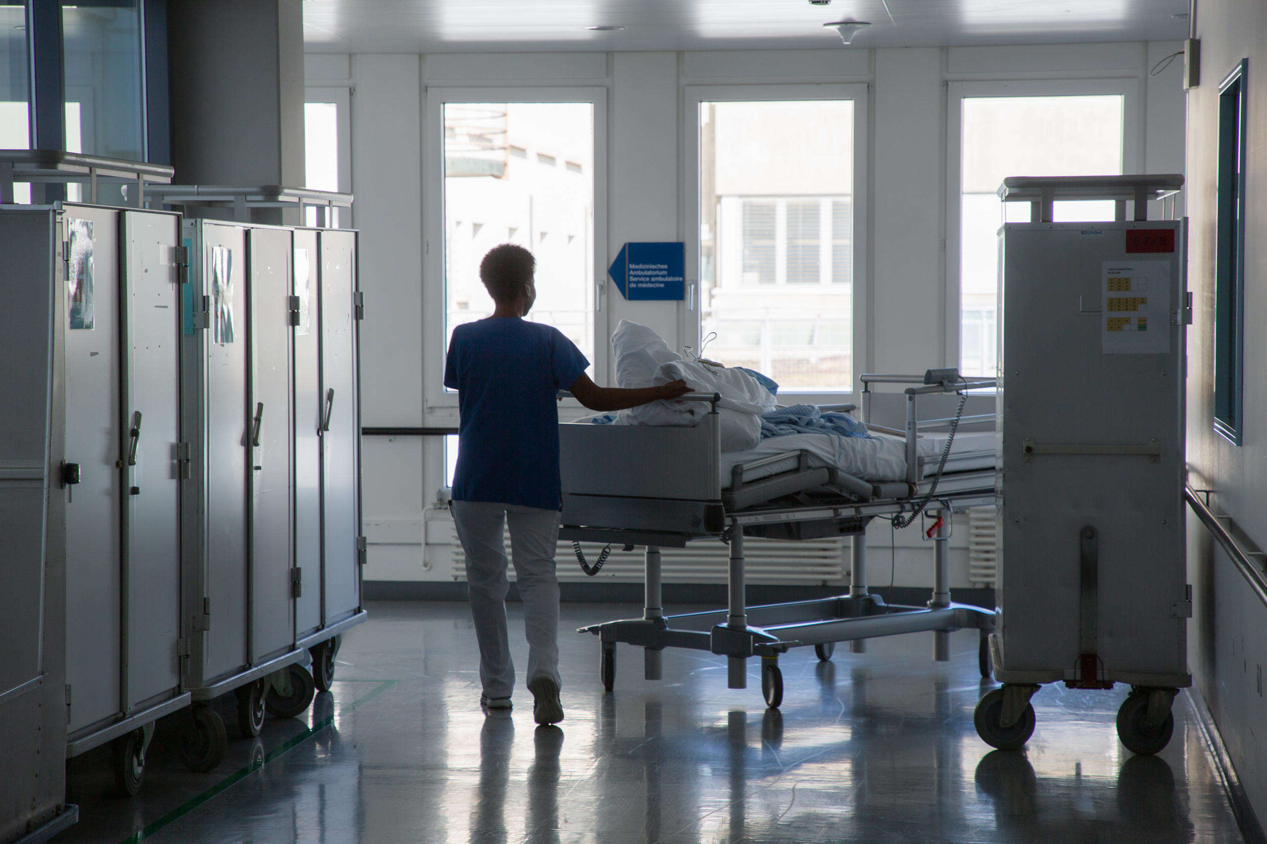 Woman moves bed in hospital