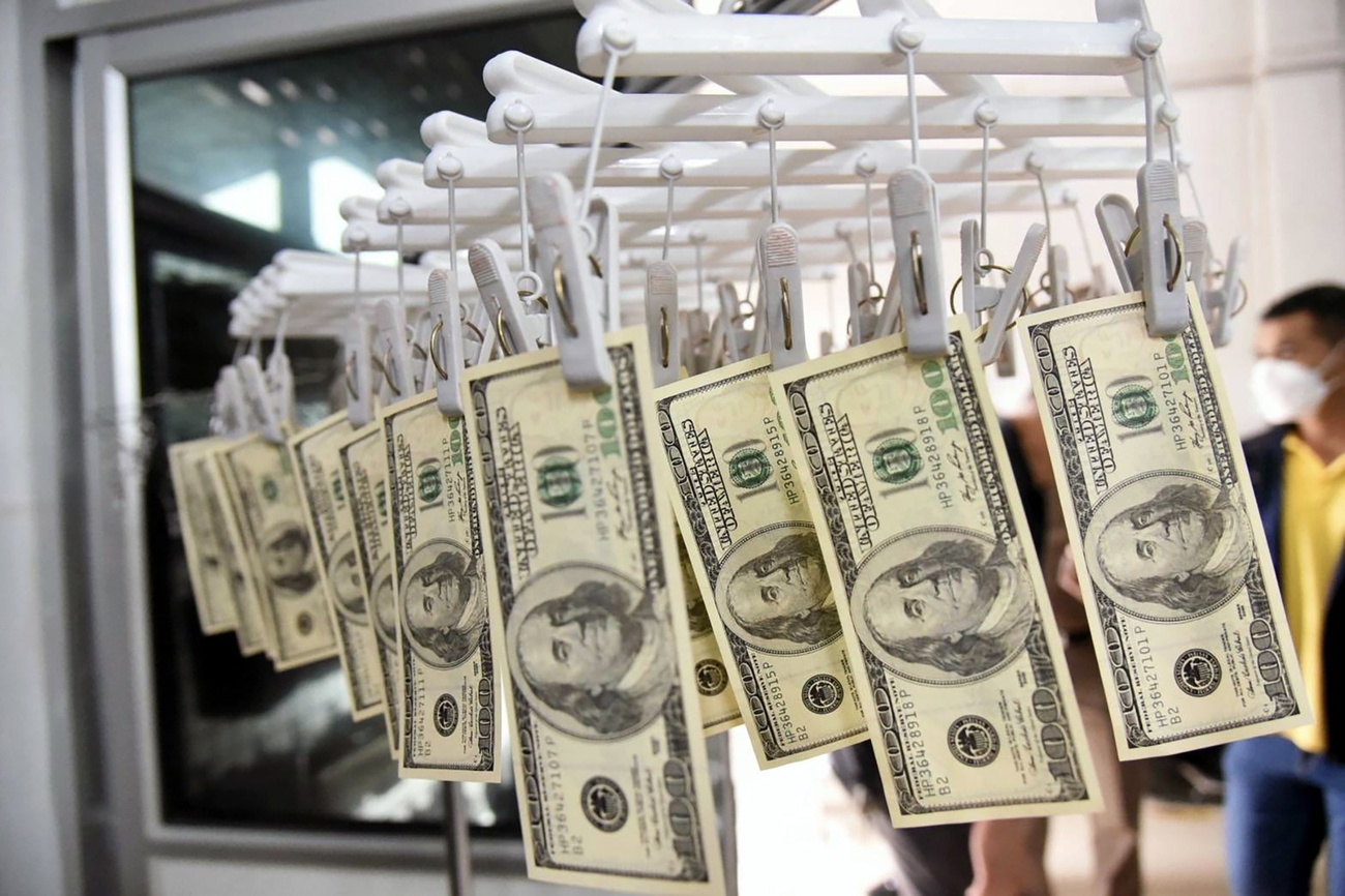 Dollar bills drying on clothes pegs