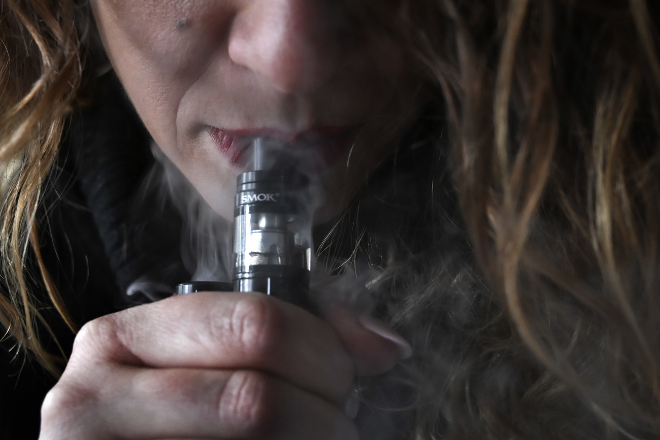 young woman smoking e-cigarette