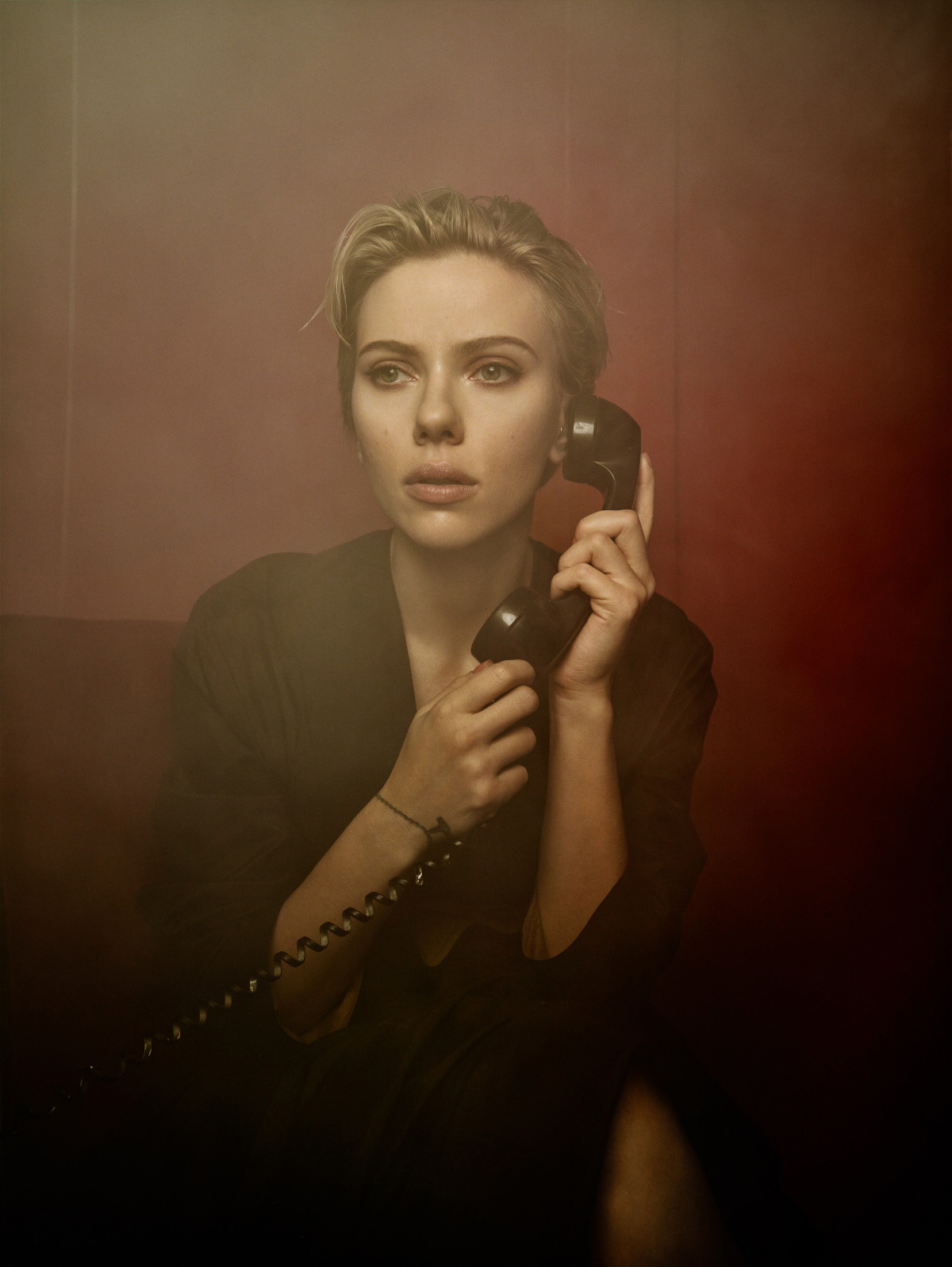 Photograph of actress Scarlett Johansson holding a black handset.