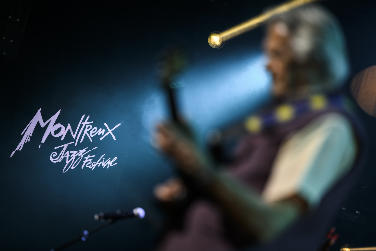 Guitarist on stage with Montreux Jazz logo