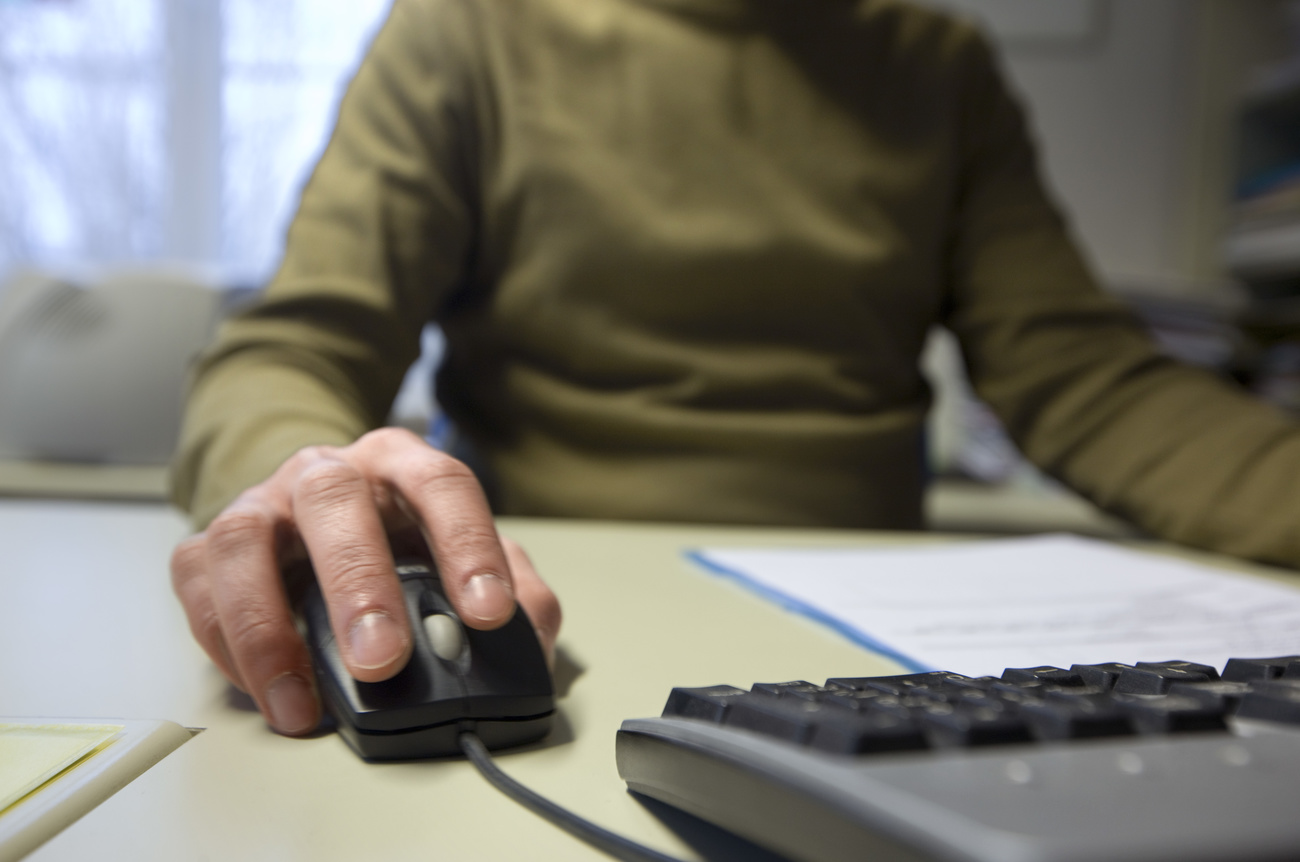 person with computer mouse and keyboard