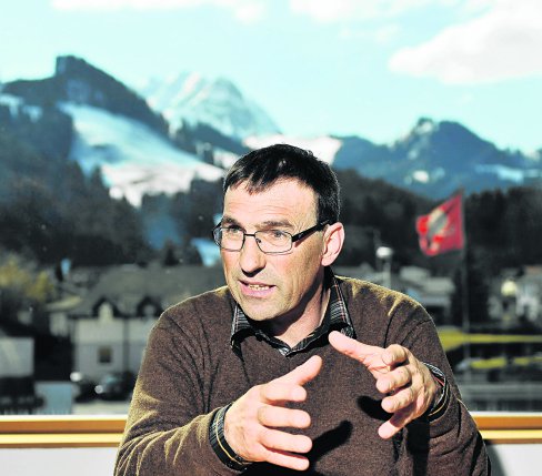 Man, Philippe Bardet, Director of the Gruyère consortium speaking with mountain landscape in the background