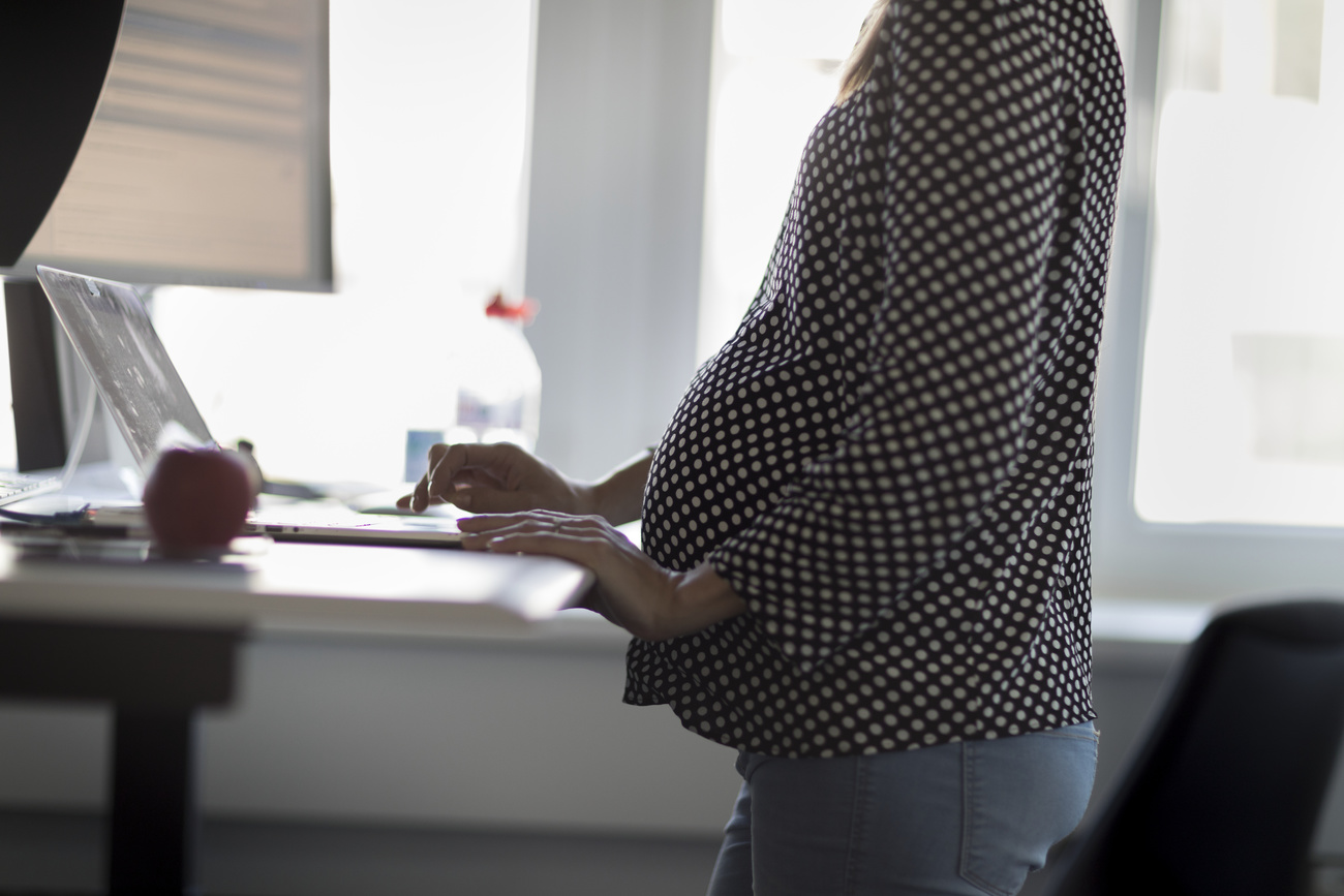 Pregnant woman working at standing desk