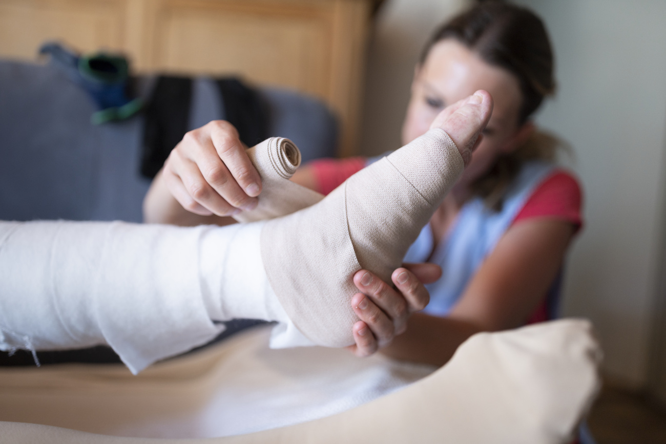 Nurse bandaging patient s foot