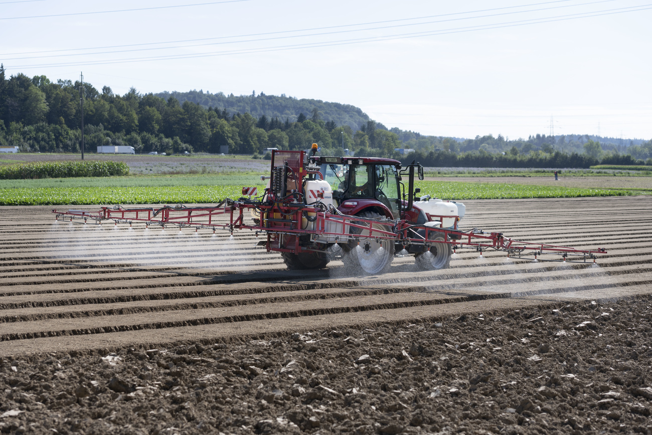 Tractor sprays a field