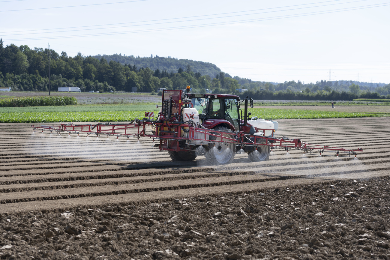 Tractor sprays a field
