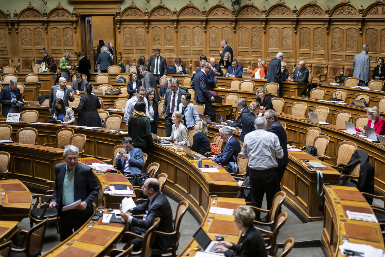 the Swiss parliament in session. Members casually in the chamber.