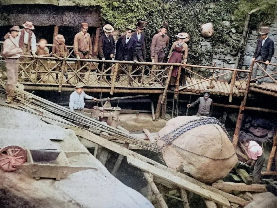 A round boulder is recovered on a wooden ramp