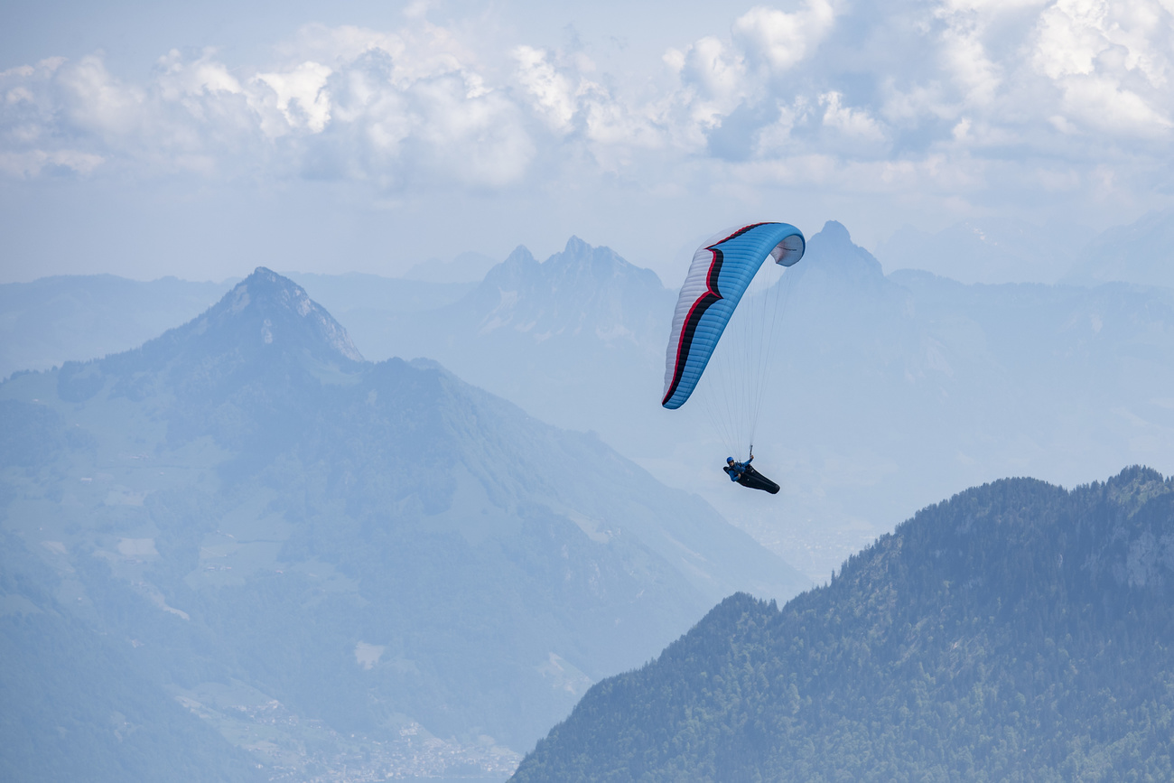 Paraglider in the air above Swiss mountain