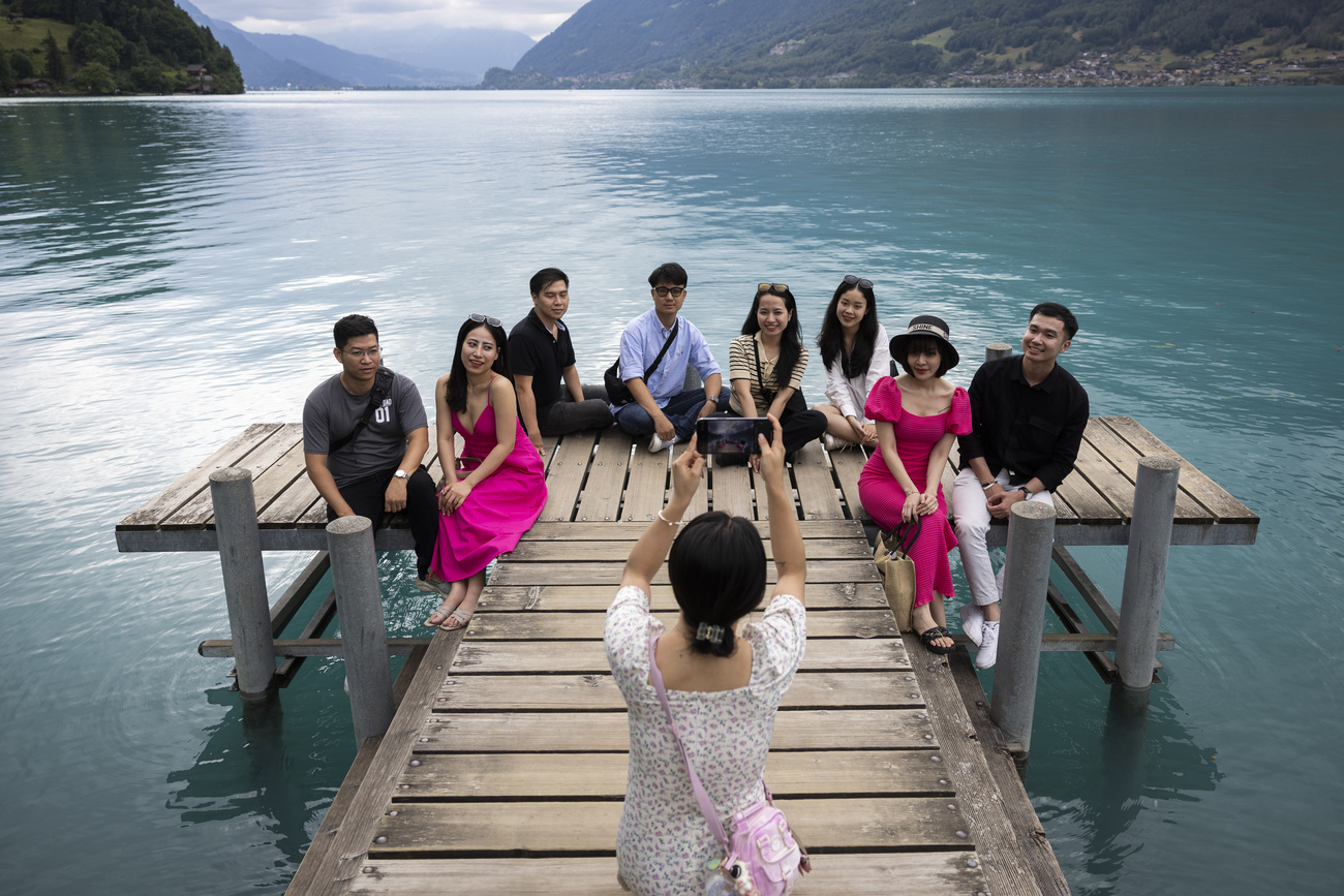 Tourists taking photos on the Iseltwald pier