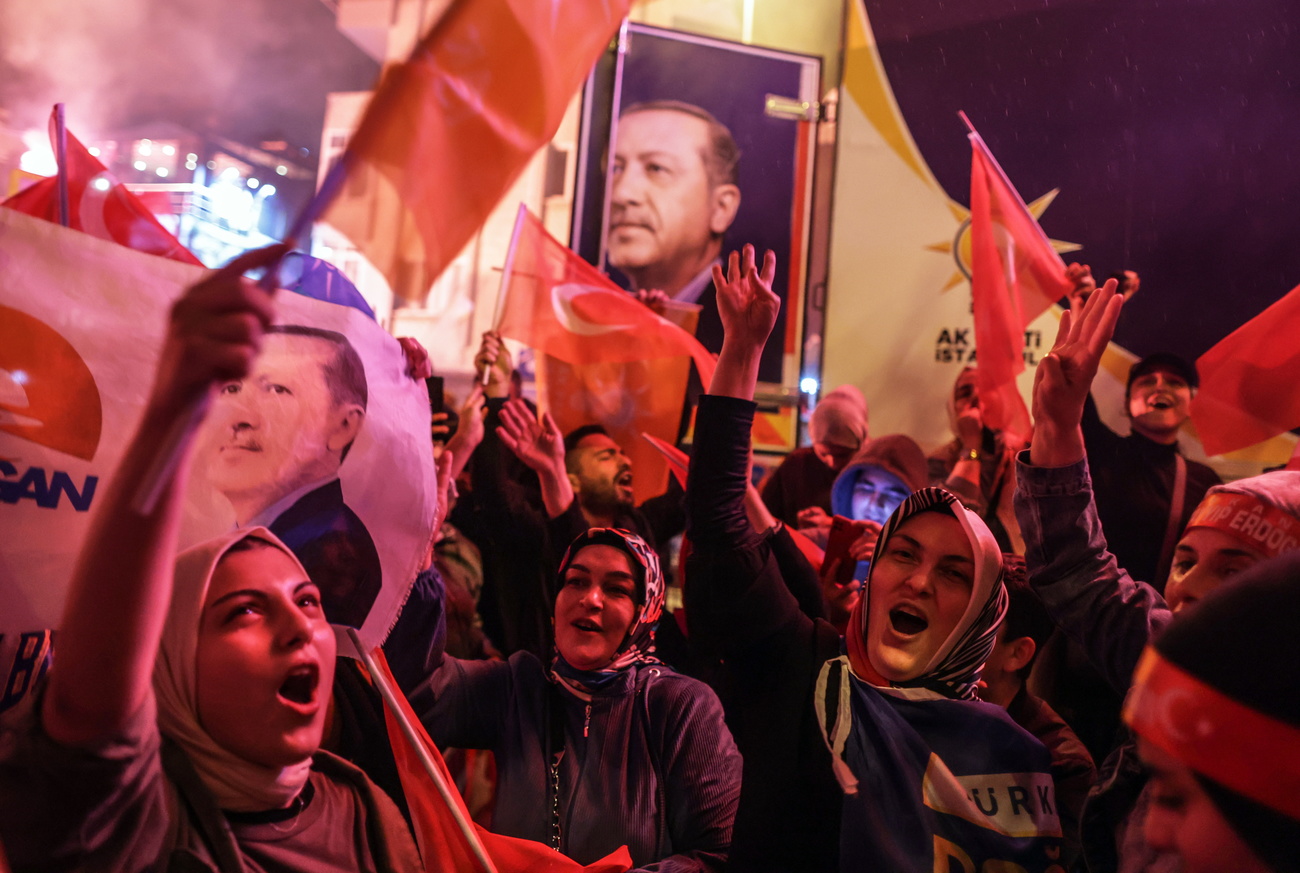 Turkish supporters of Erdogan celebrate his victory in presidential election on Sunday,