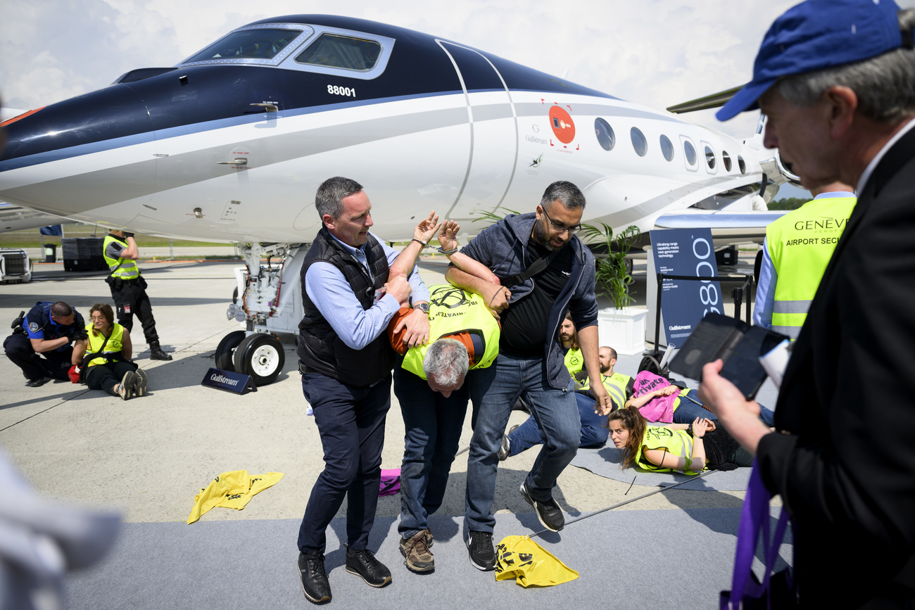 Picture of a man being arrested by police in front of plane