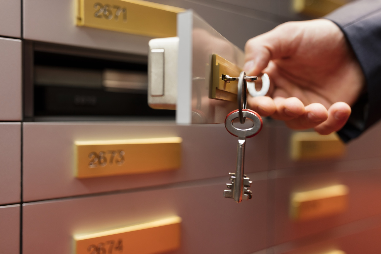 Person opening a bank vault with keys