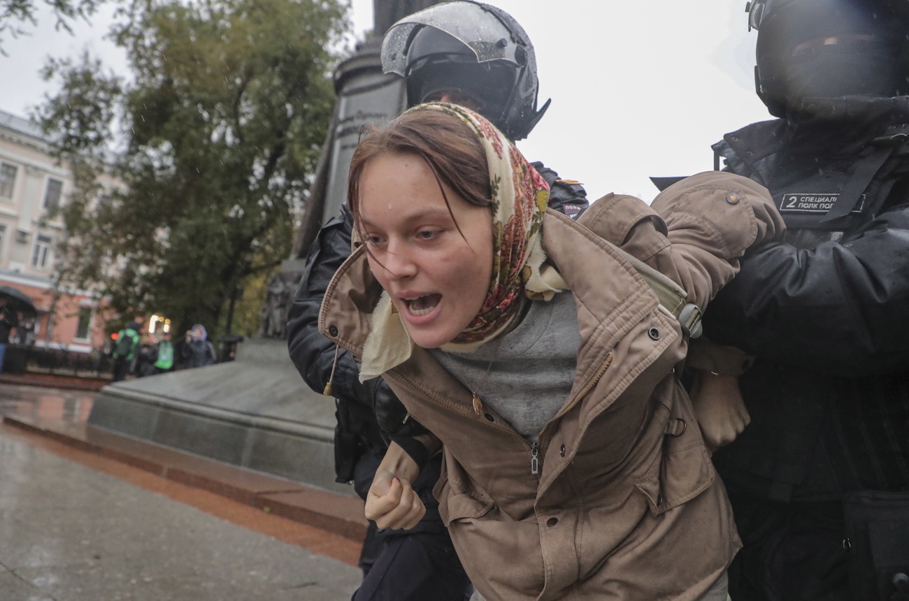 Woman arrested by police in Moscow during protest against Ukraine war mobilisation.