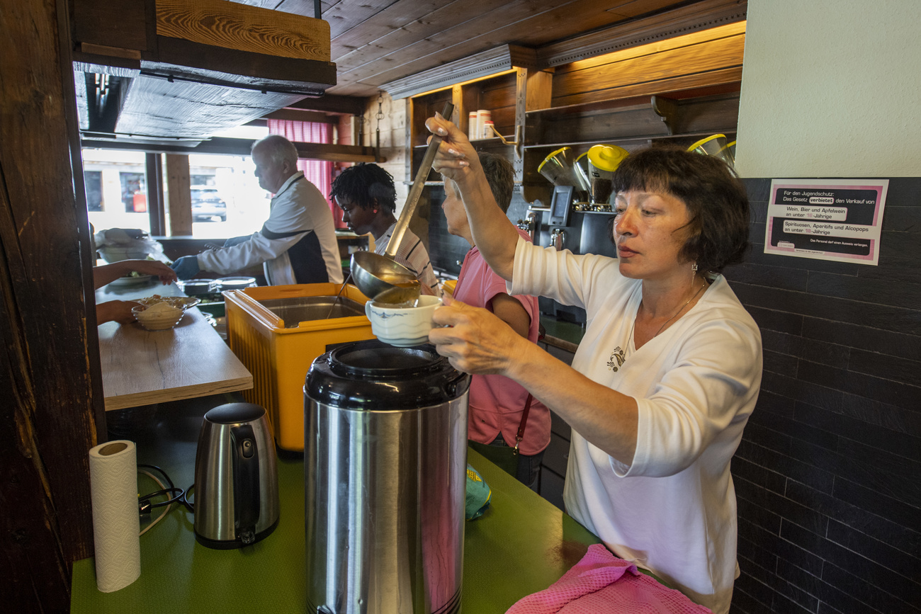 Photo of a Ukrainian woman making soup in a hotel restaurant.