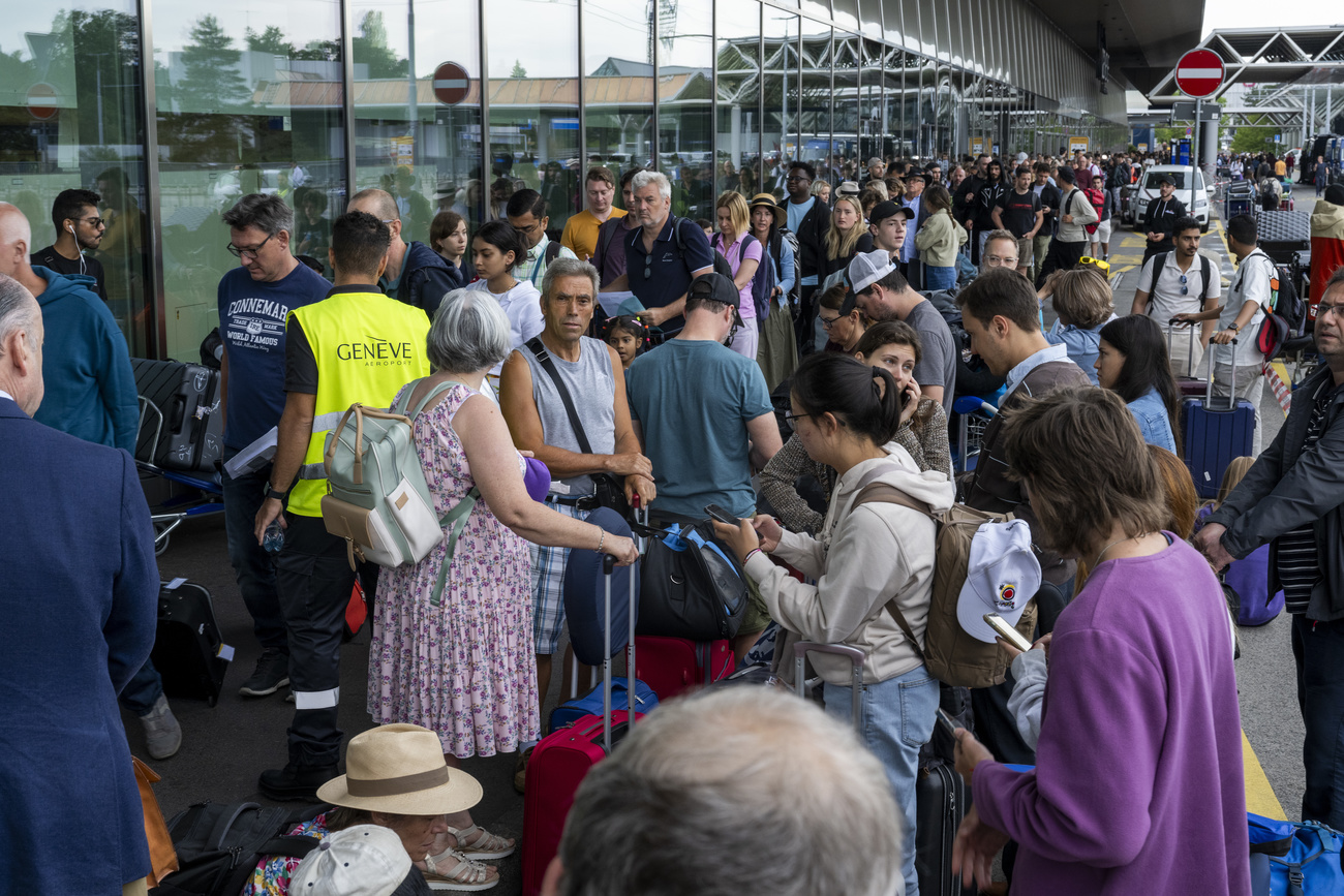 Passengers queue at Geneva airport on a day of strike action.
