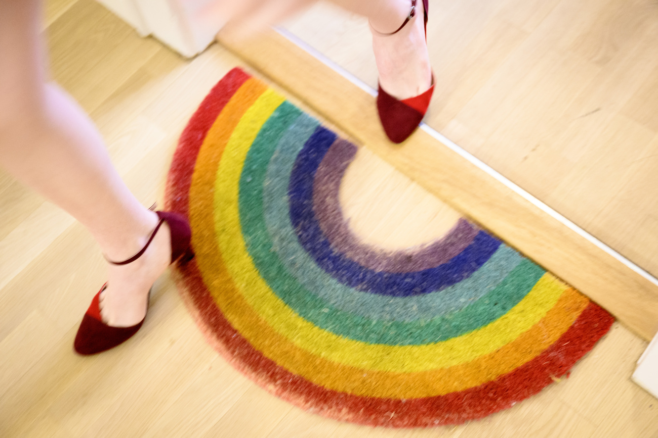 woman steps on rainbow mat