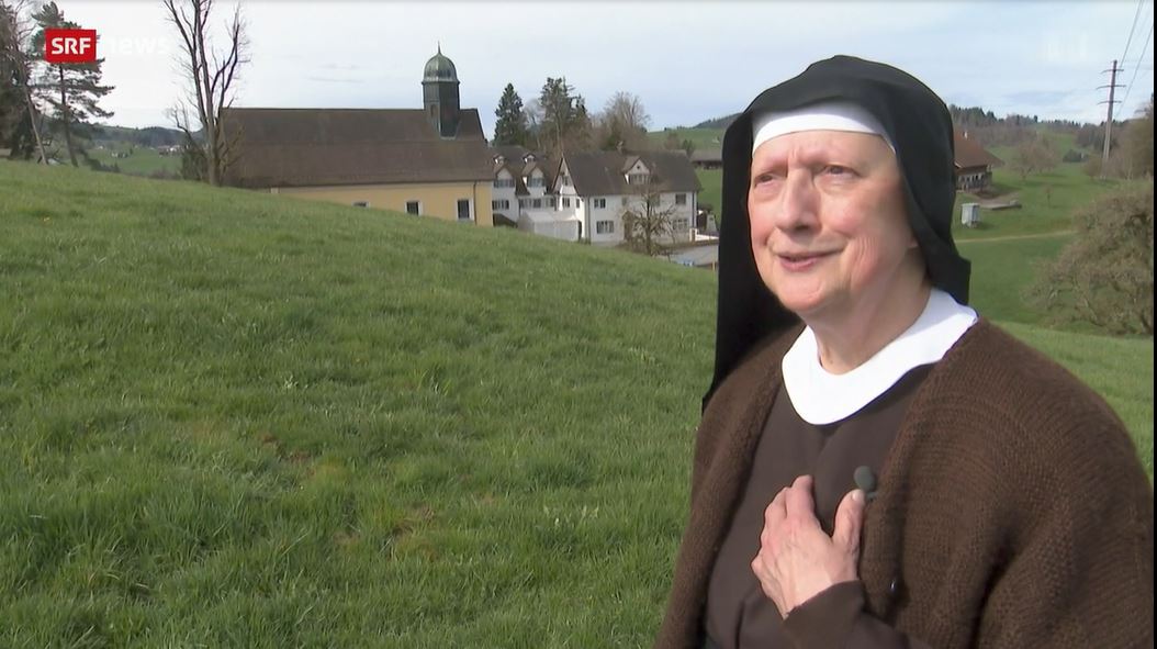 The nun with the convent behind her Appenzell