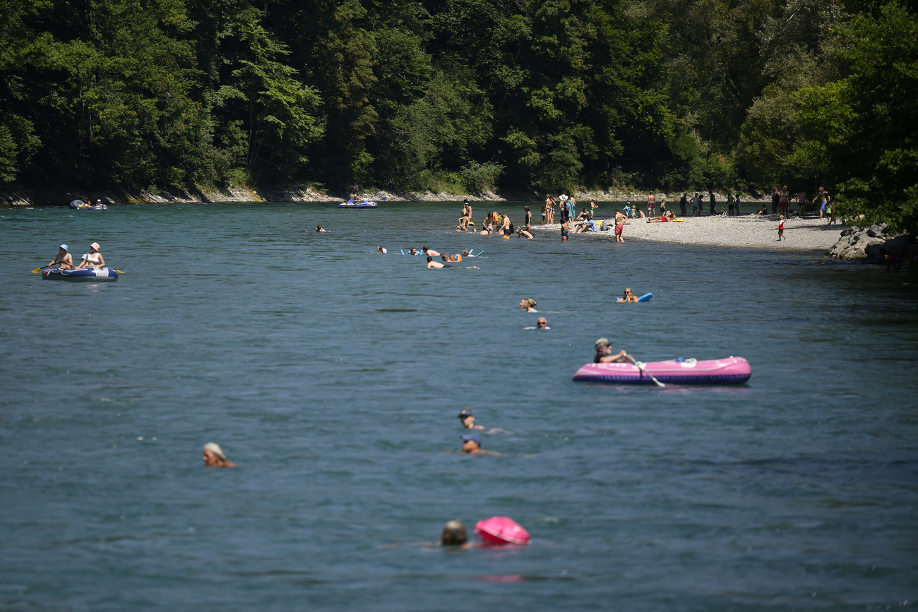 Photo of river with people swimming in it