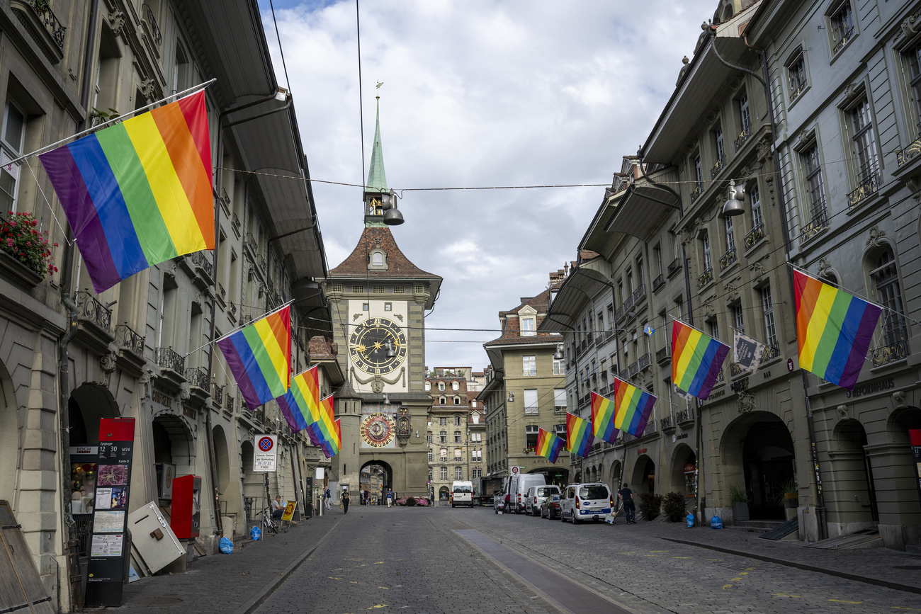 medieval-looking street in bern with lots of rainbow flags
