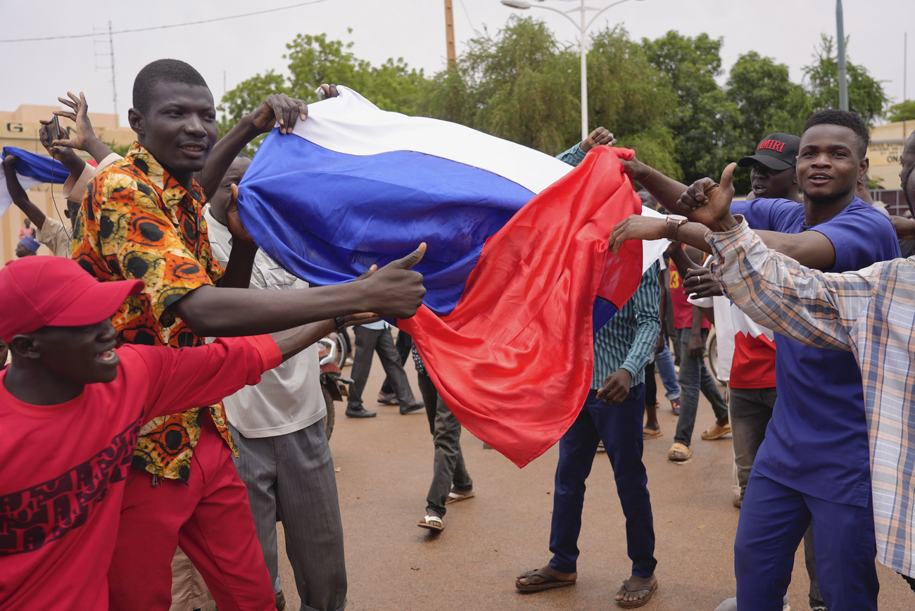 Supporters of the Niger military coup wave Russian flags in the streets.