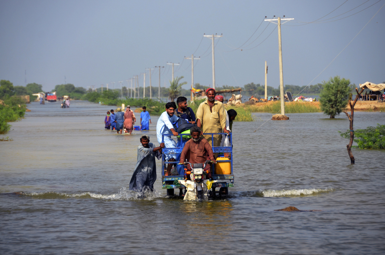 People navigating floods in Pakistan in September 2022