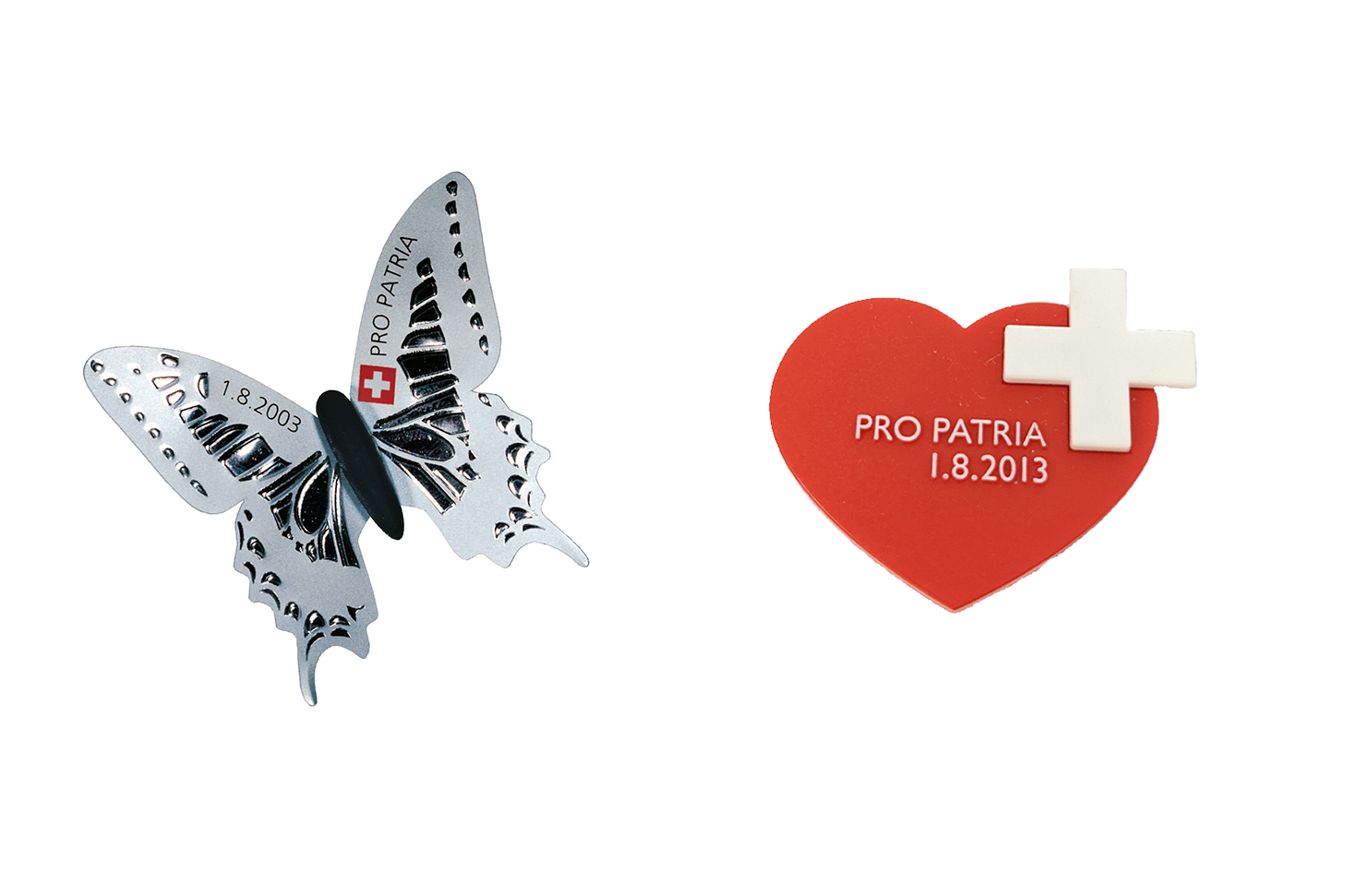 A black and white tin Butterfly on a white background, next to a heart illustration with white cross pro patria written