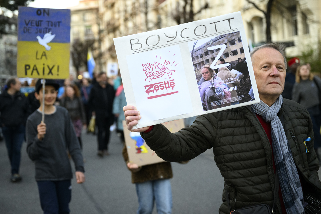 Protester in Lausanne carrying placard to boycott Nestle