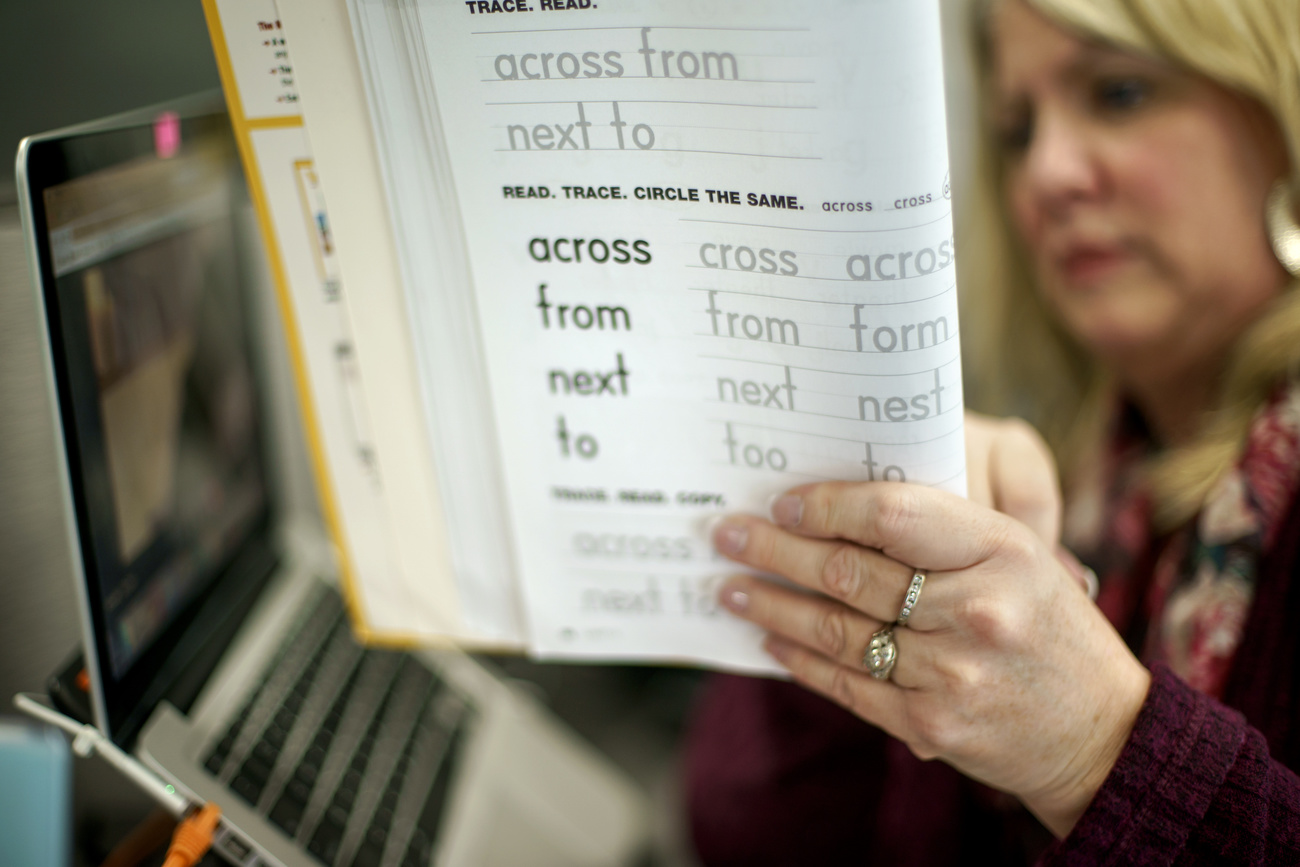 woman holding English teaching book