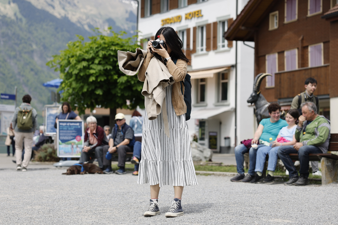 Photo of a woman taking a picture in a square