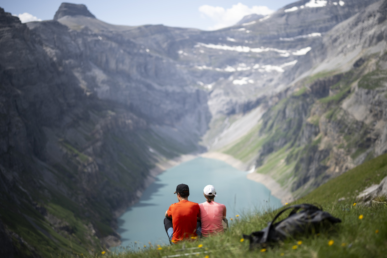 Walkers in the Swiss Alps on a hot August day.