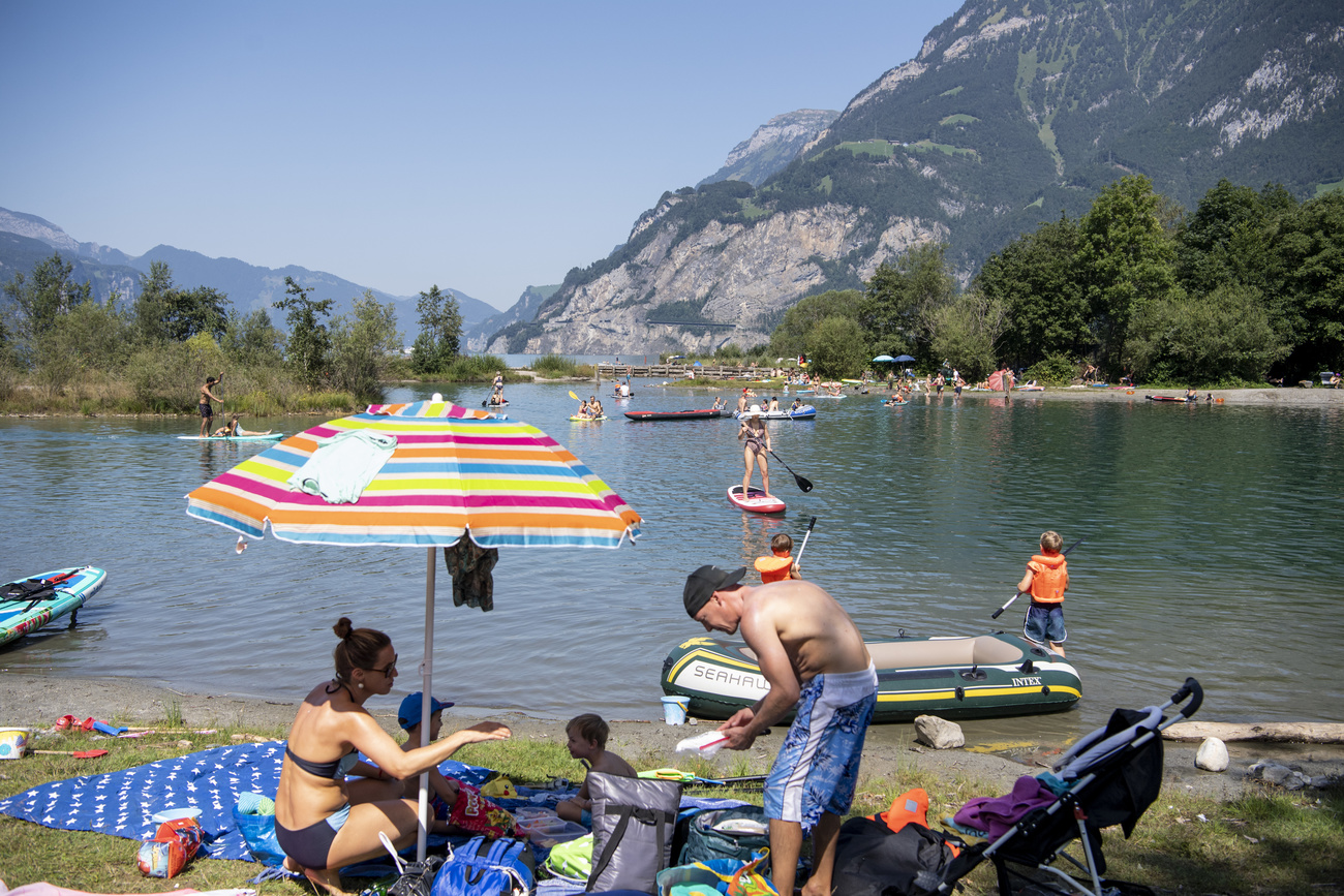 People sunbathing by Urner Lake