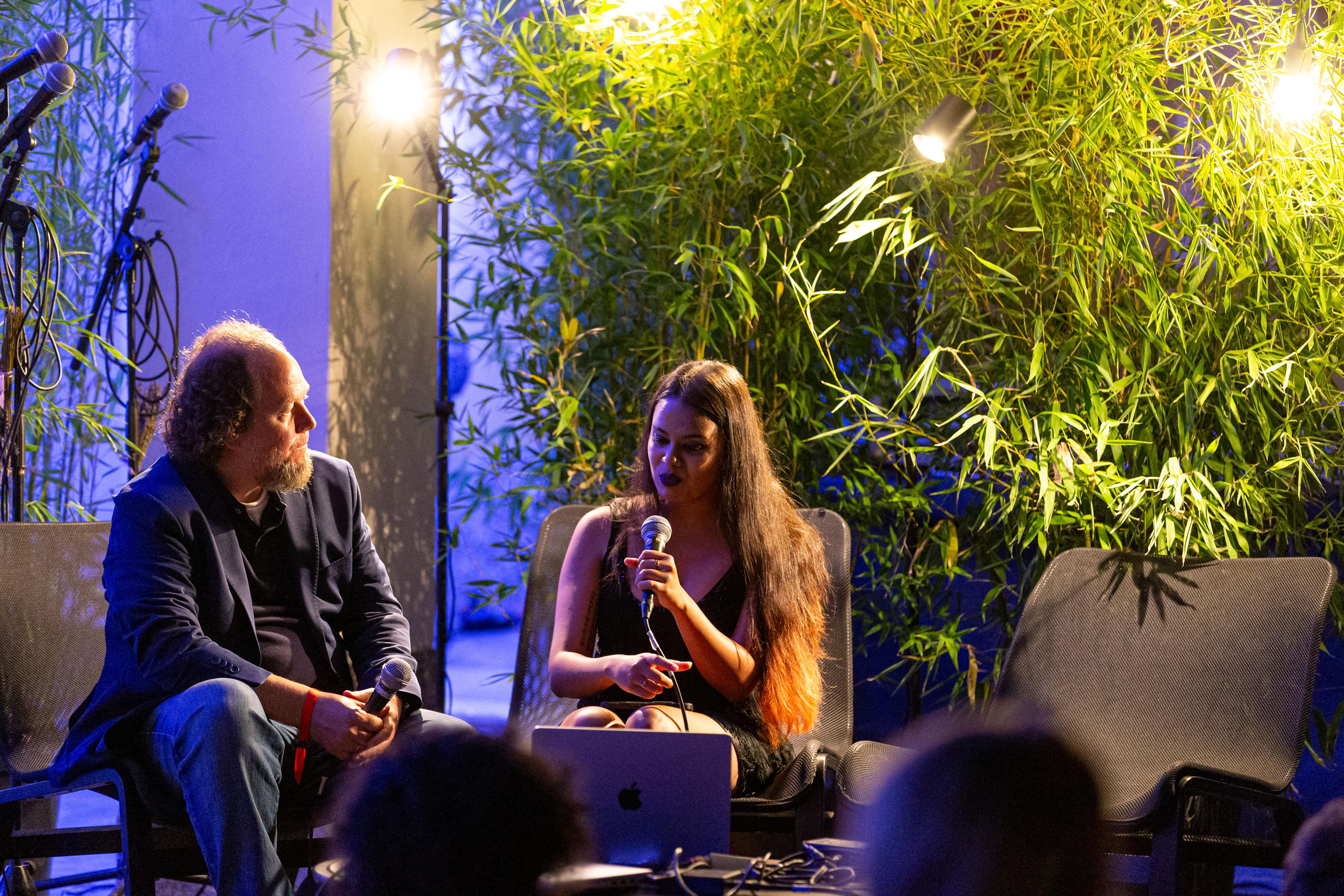 A man and a woman talking in a podium