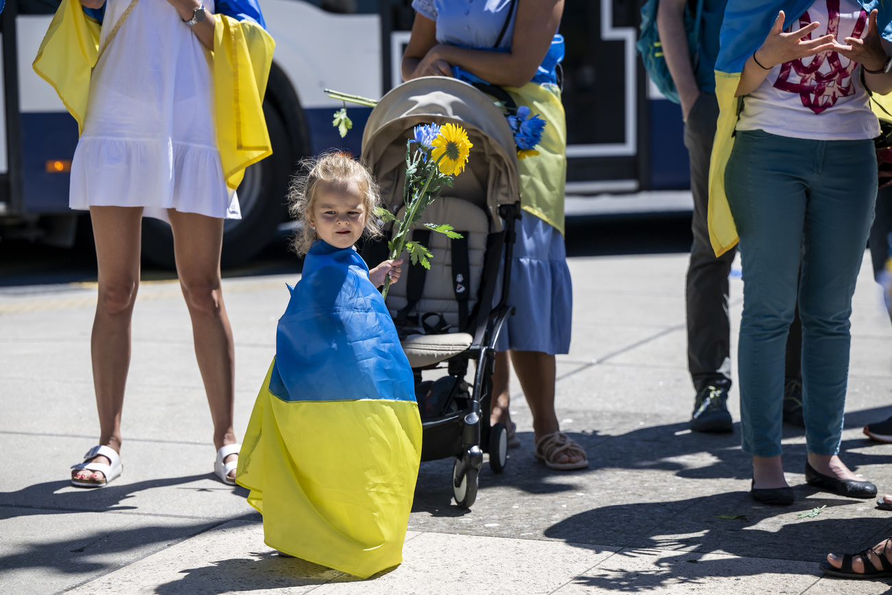 Photo of a young girl wearing a Ukrainian flag