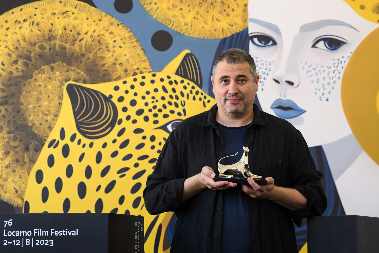 Radu Jude posing with his Pardo award