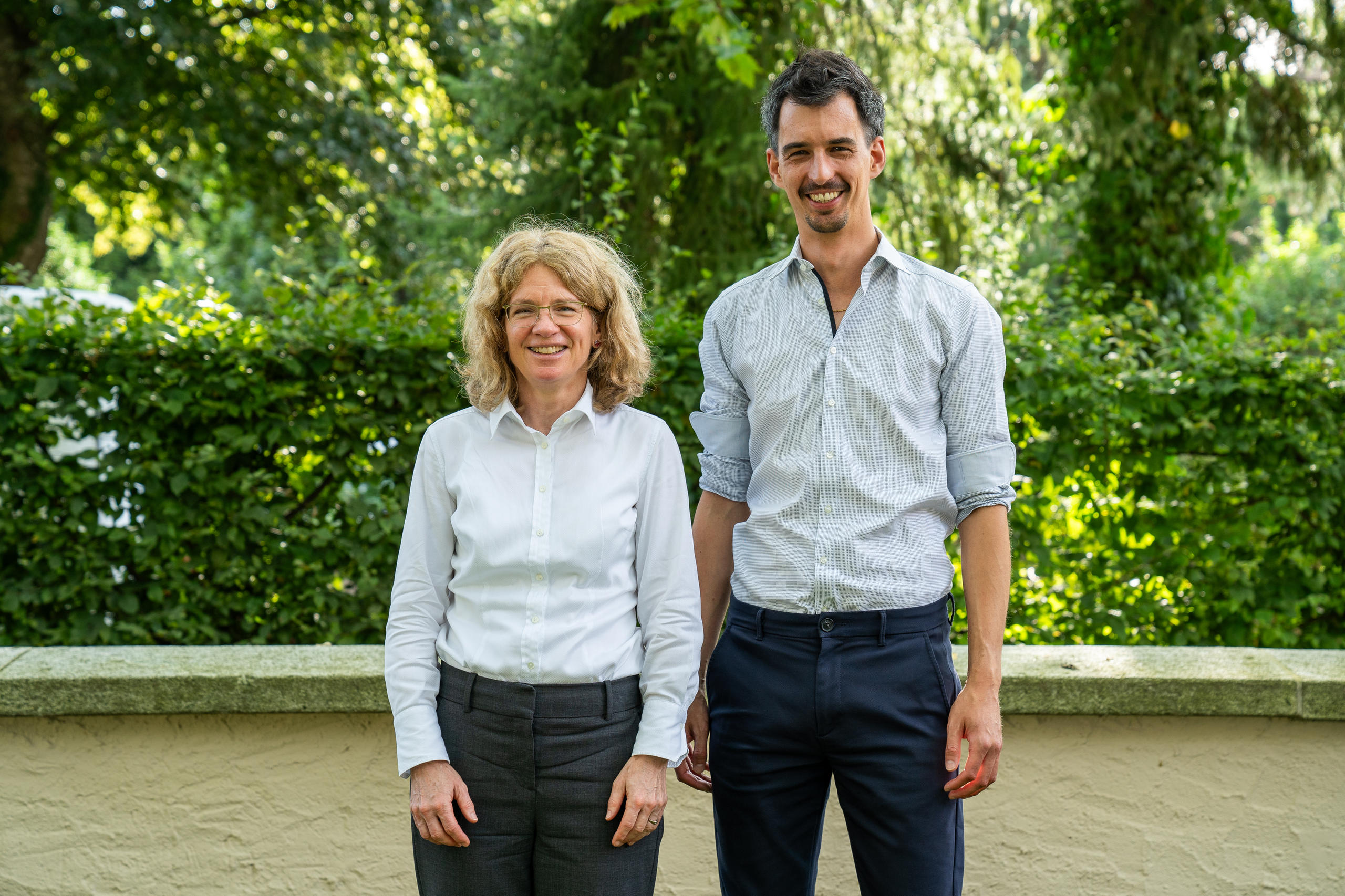 Stephanie Schmitt-Grohé and Fabio Canetg in business casual clothing outside