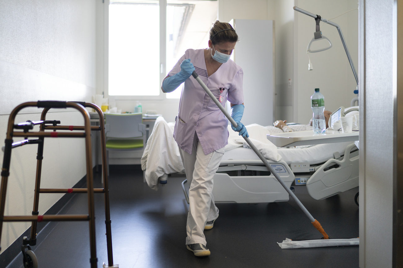 Woman cleaning hospital room