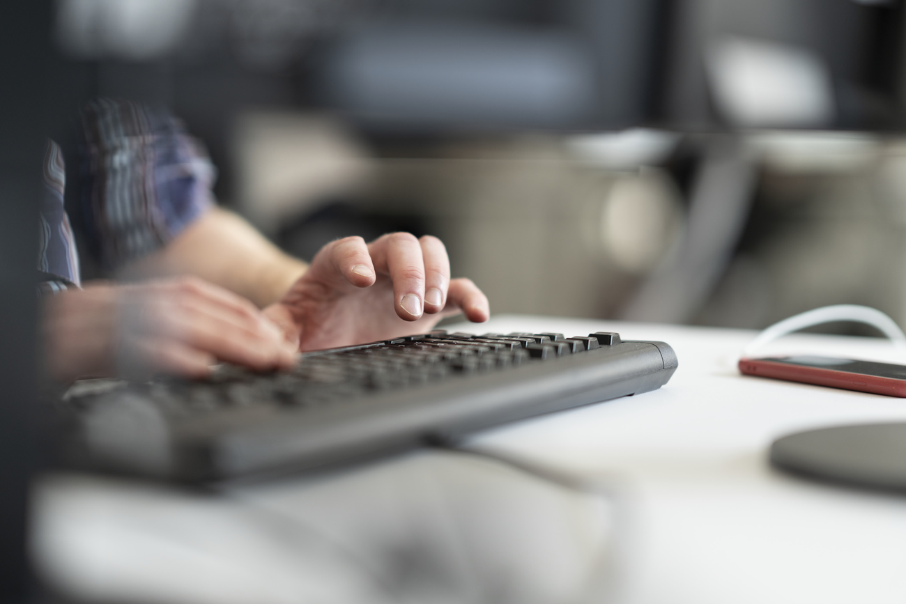hands tapping on a computer keyboard