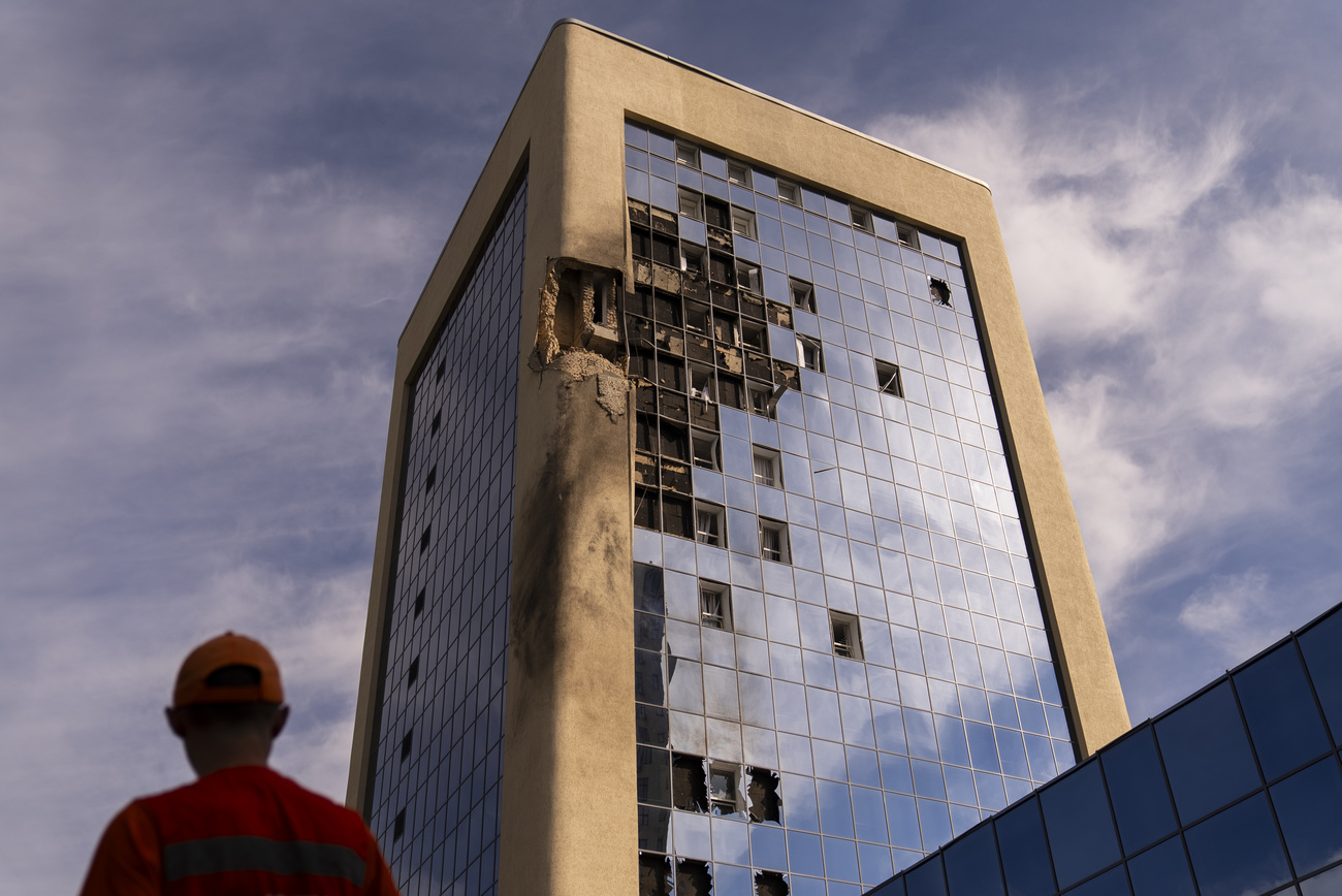 tall building with bomb-damaged holes