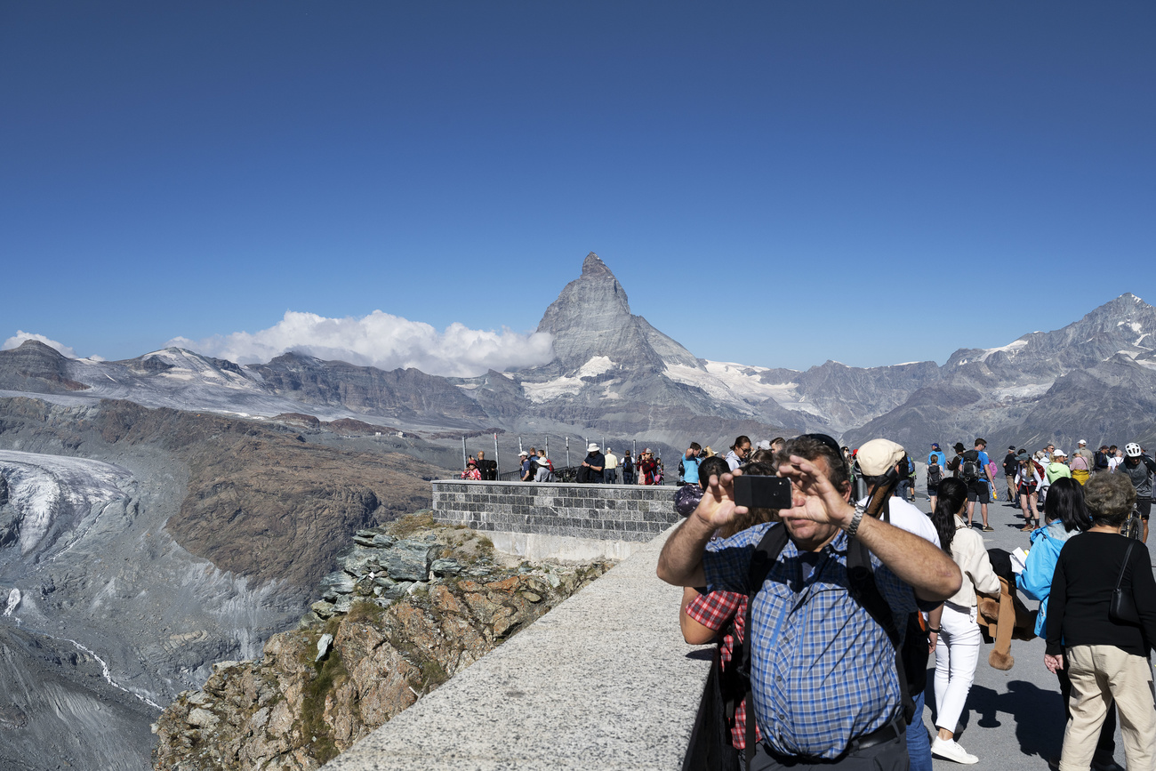 Tourists taking pictures of the famous Zermatt alp