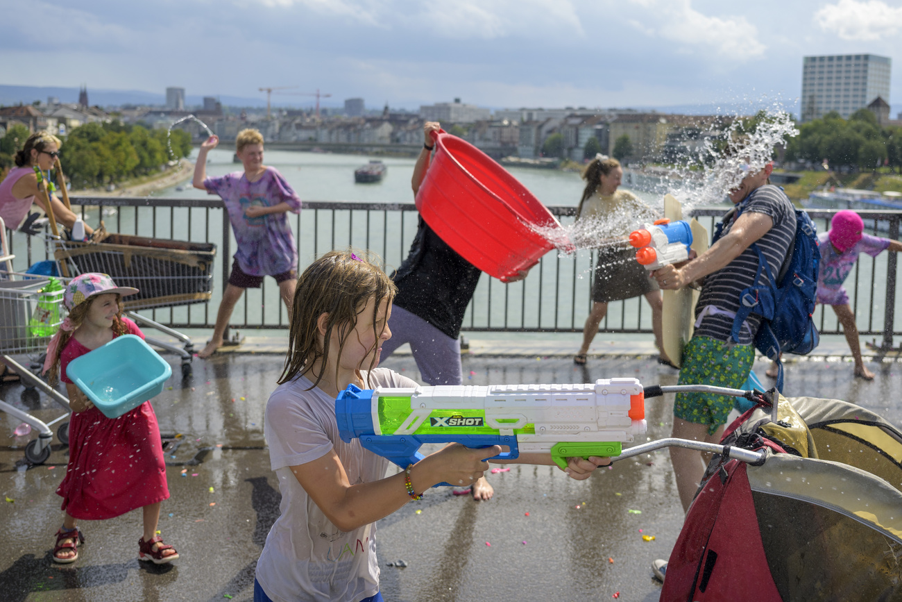 People throw water over each other in Basel.