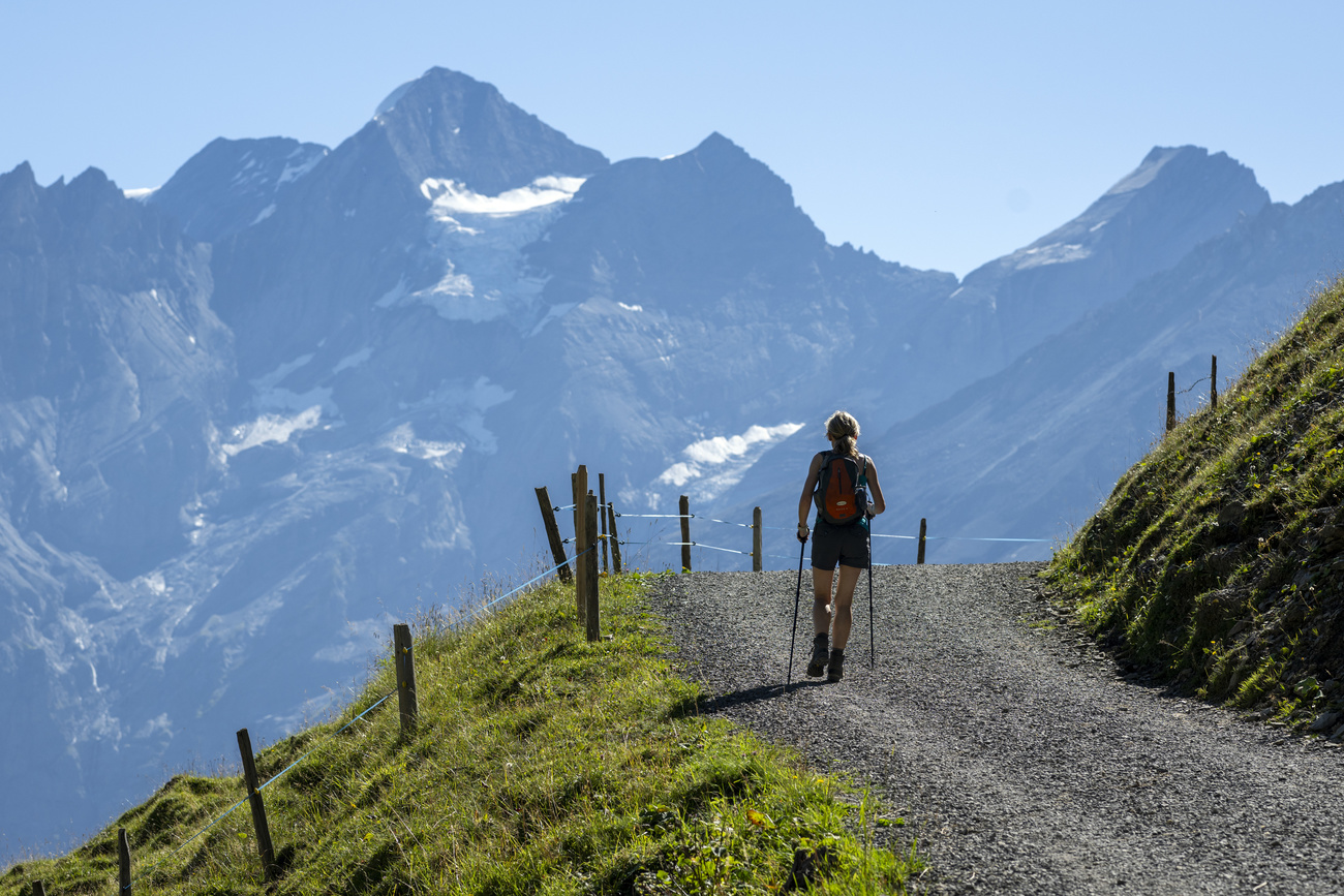 Woman walking in the Swiss Alps.