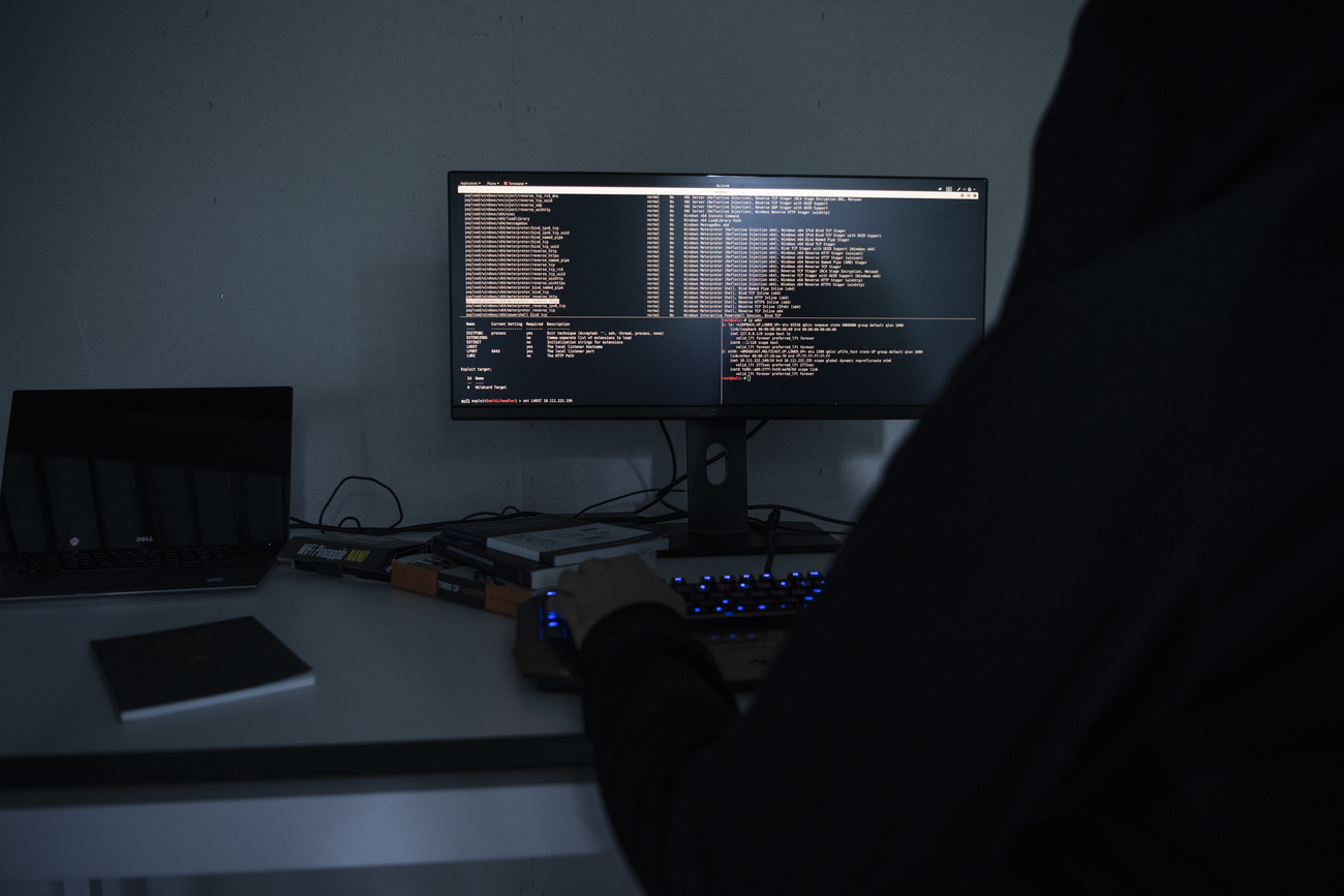 Computer monitor at a desk in a dark room