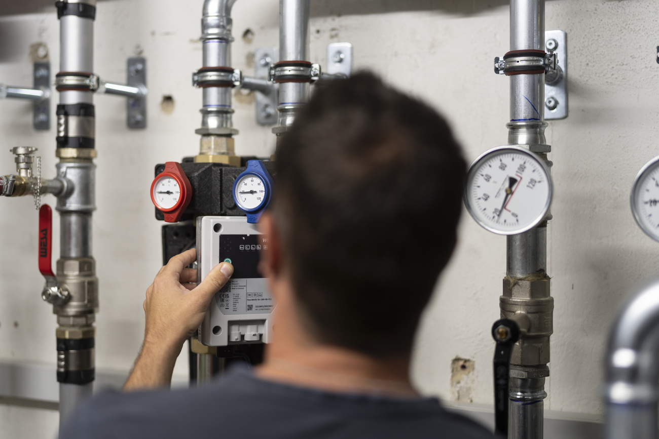 Man looking at heat pumps