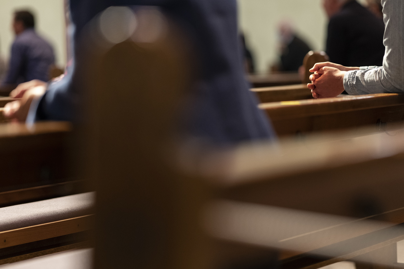 People praying in a Catholic Church