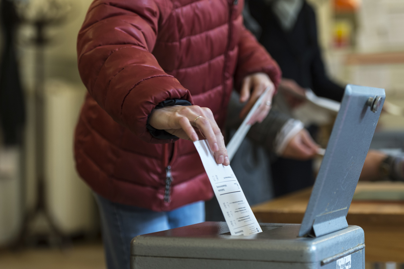 Person puts voting paper in ballot box