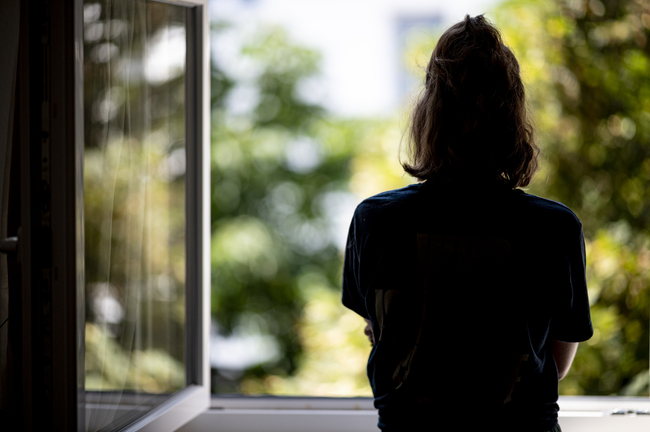 symbolic image depression woman stands at window