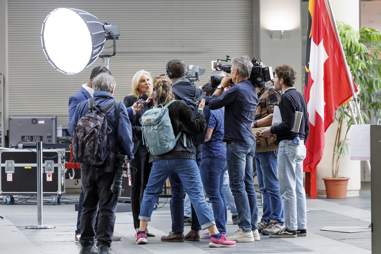 politician Celine Amaudruz surrounded by journalists